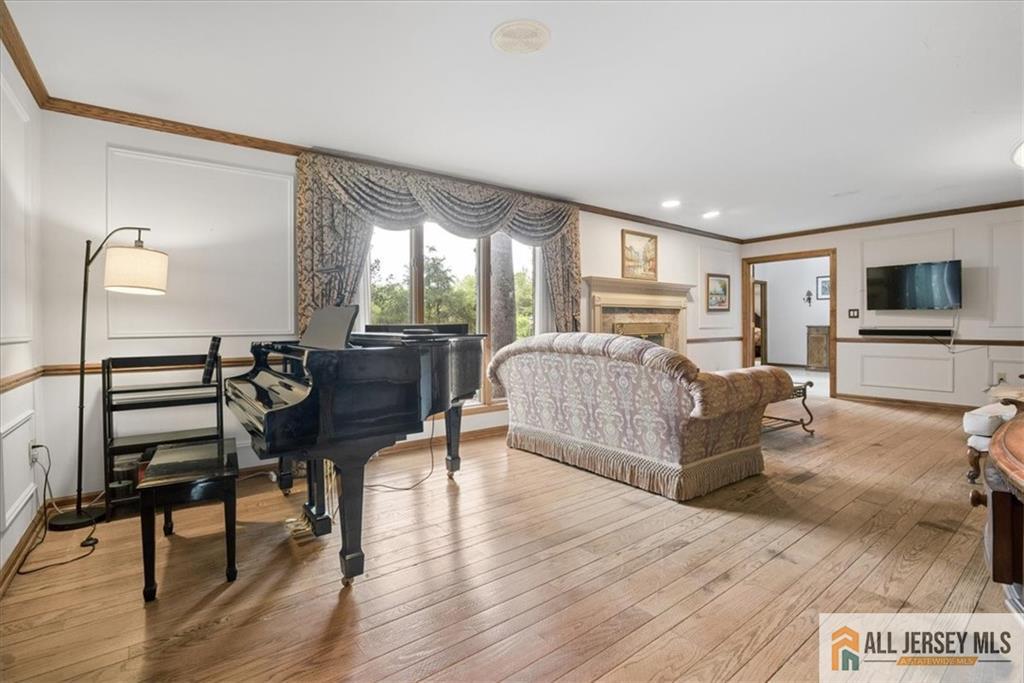 167 Federal Road Monroe Township, NJ 08831 - Photo 6 of 46 a living room with furniture a flat screen tv and wooden floor