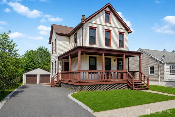 a front view of a house with a garden and deck