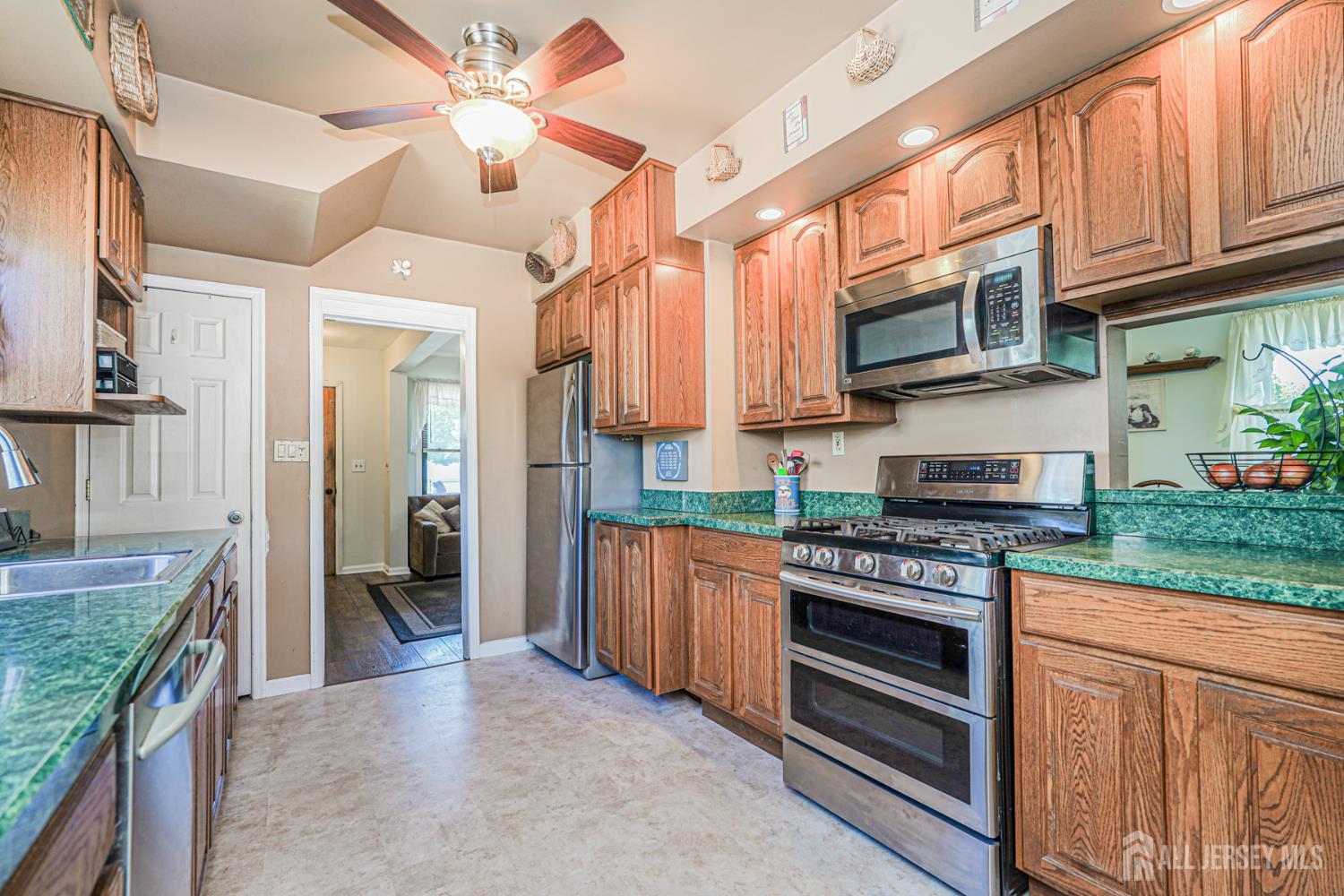 12 Fox Road Edison, NJ 08817 - Photo 11 of 21 a kitchen with stainless steel appliances granite countertop a stove top oven a sink and dishwasher a oven with granite countertops
