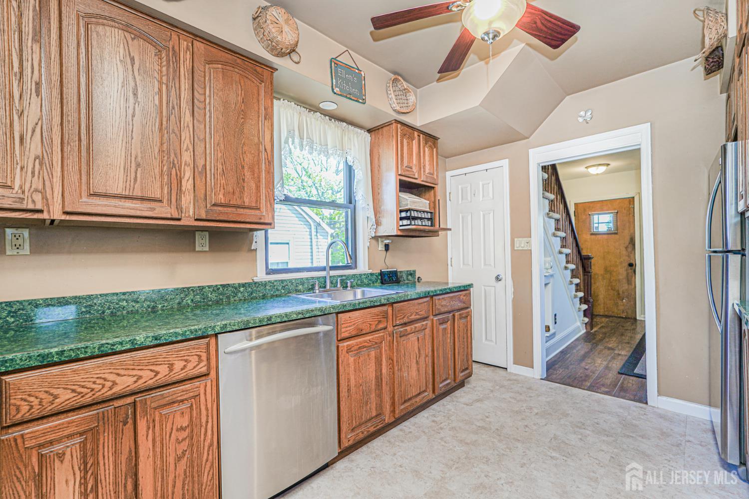 12 Fox Road Edison, NJ 08817 - Photo 12 of 21 a kitchen with granite countertop a sink window and cabinets