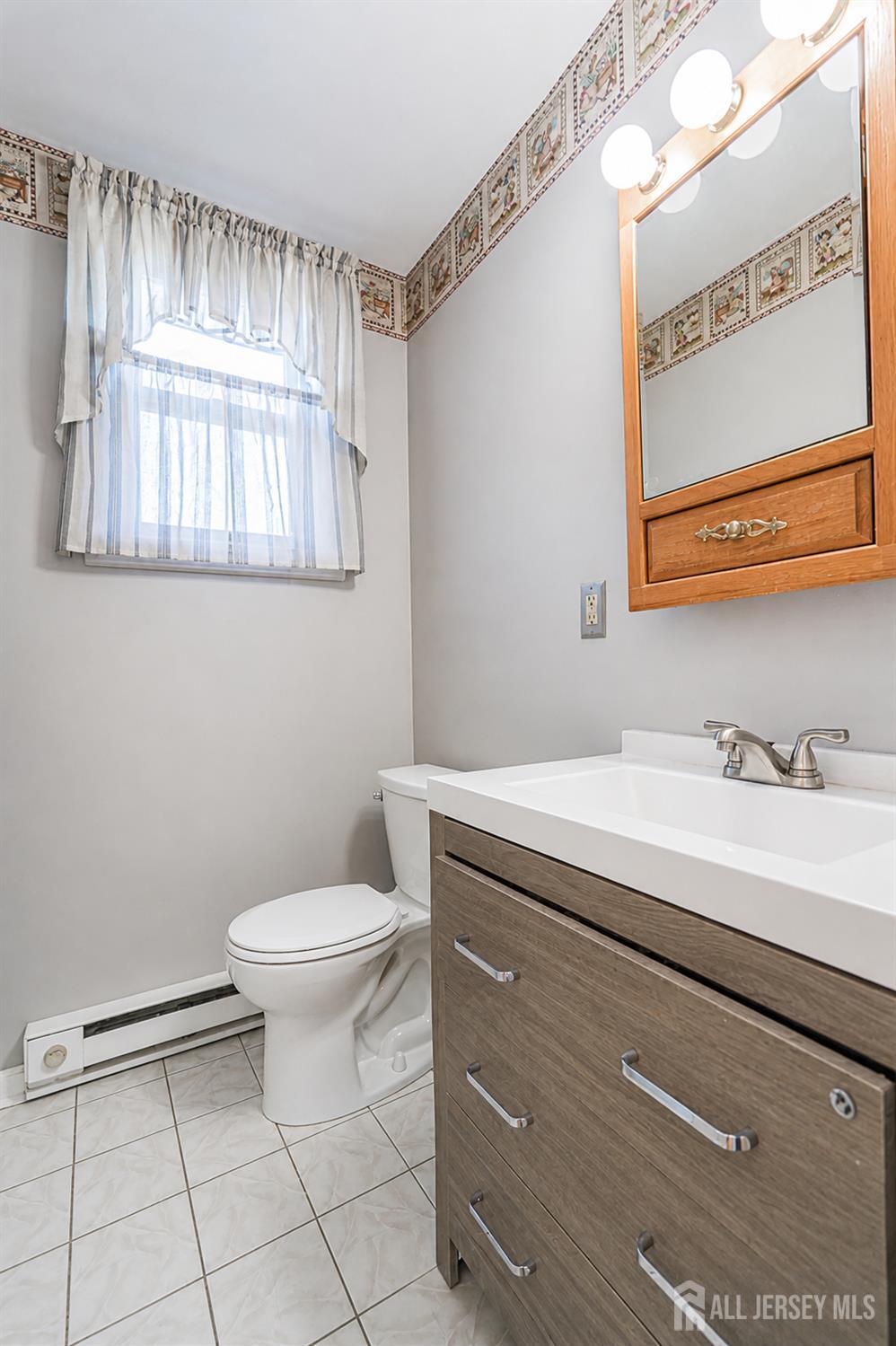 12 Fox Road Edison, NJ 08817 - Photo 13 of 21 a bathroom with a granite countertop sink mirror vanity and toilet
