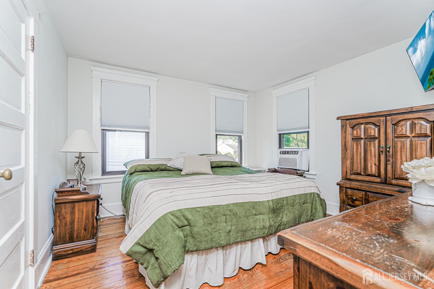 12 Fox Road Edison, NJ 08817 - Photo 14 of 21 a bedroom with a bed and wooden floor