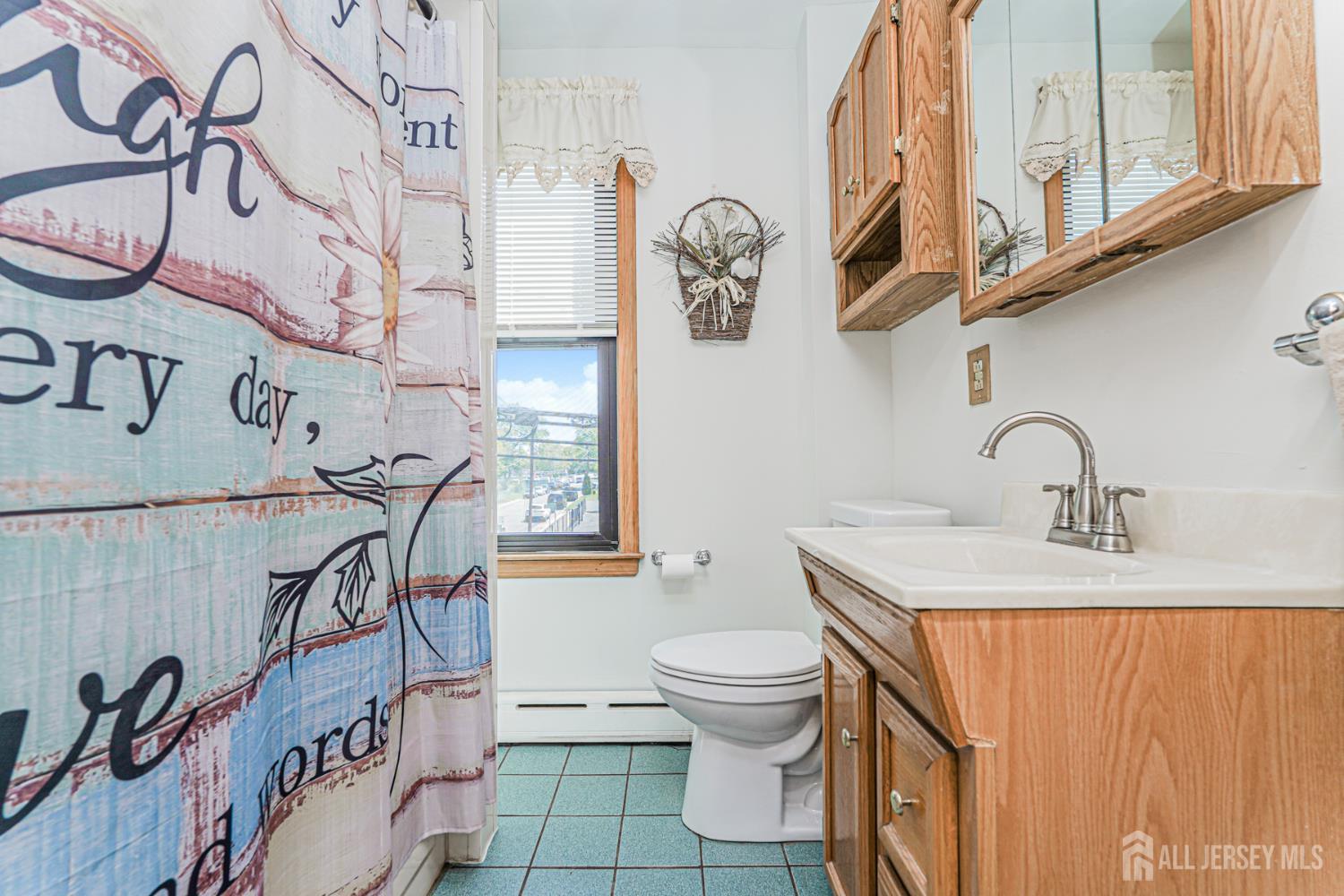 12 Fox Road Edison, NJ 08817 - Photo 18 of 21 a bathroom with a sink a toilet and a mirror