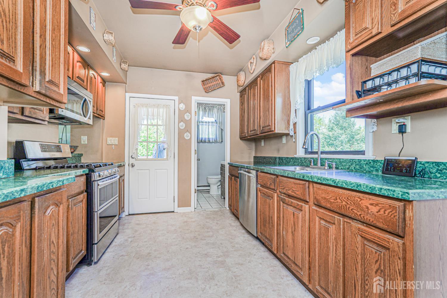 12 Fox Road Edison, NJ 08817 - Photo 9 of 21 a kitchen with stainless steel appliances granite countertop a stove and cabinets