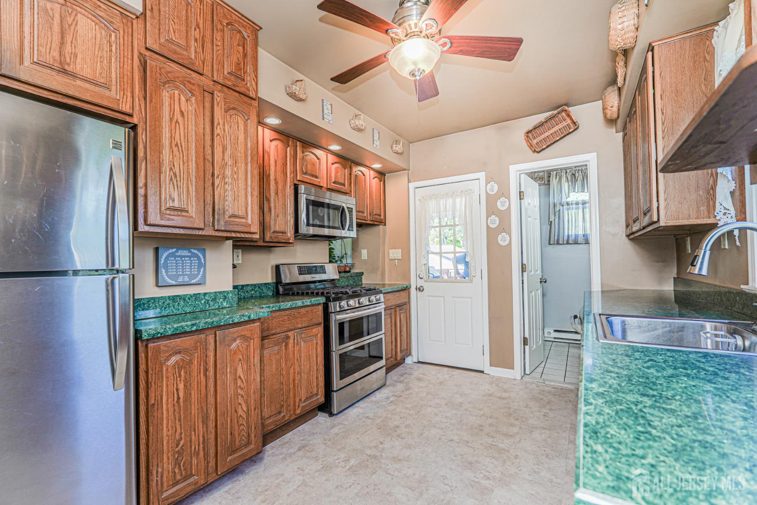 12 Fox Road Edison, NJ 08817 - Photo 10 of 21 a kitchen with stainless steel appliances granite countertop a refrigerator a stove and a sink