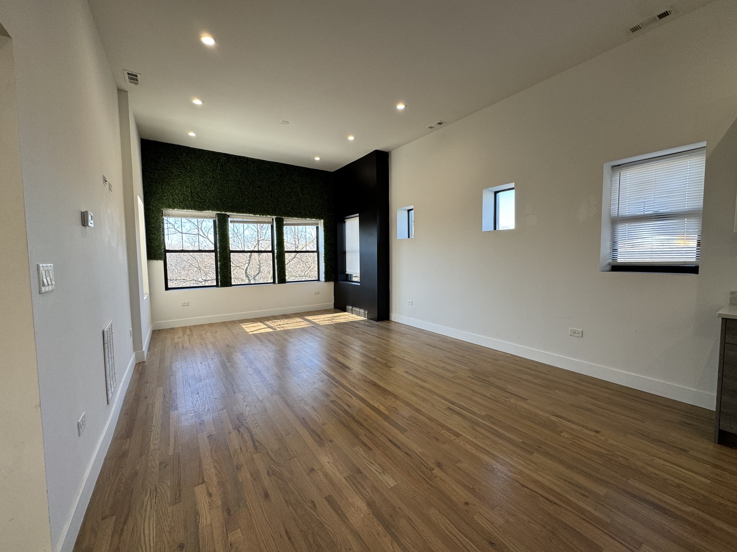 1303 South California Avenue, Unit 4W Chicago, IL 60608 - Photo 5 of 12 a view of an empty room with wooden floor and a window
