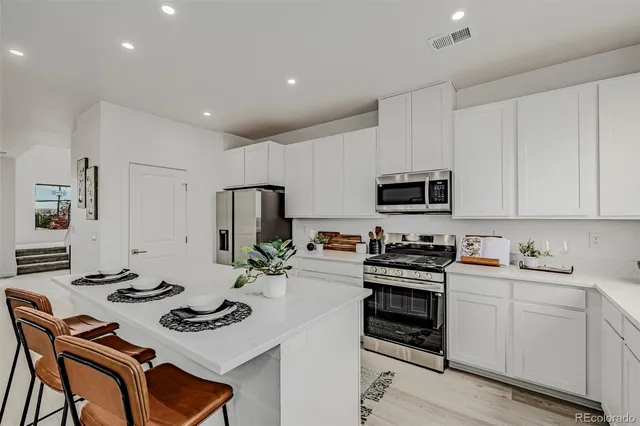 a kitchen with sink a stove and cabinets