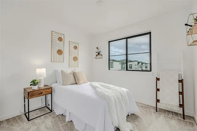 a living room with furniture a window and a potted plant