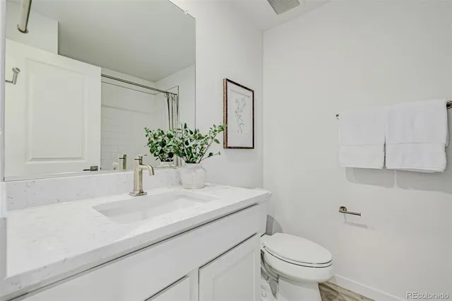 a bathroom with a sink toilet and vanity