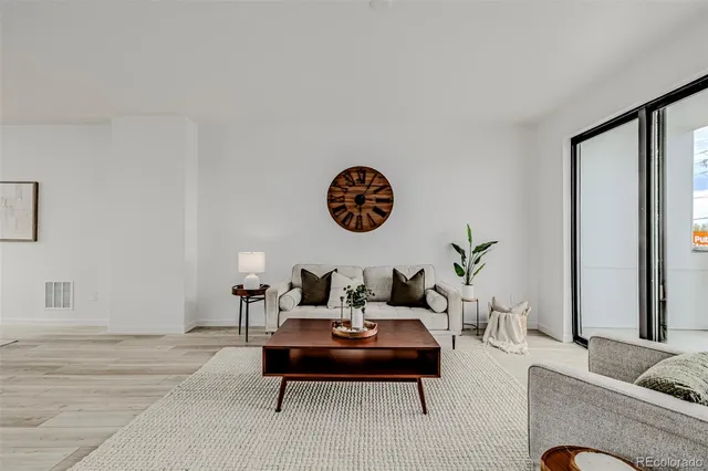 a living room with furniture and a potted plant