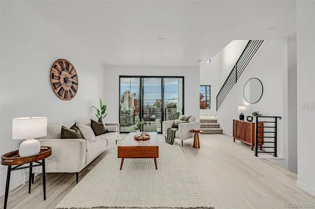 a living room with furniture a rug and a large window