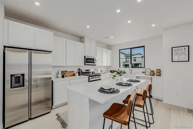 a kitchen that has a table and chairs in it