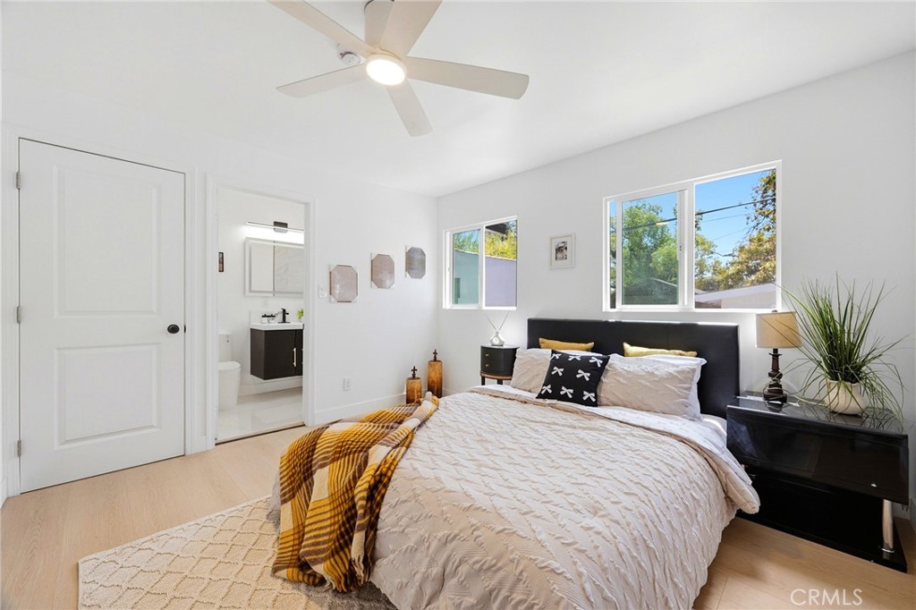 1280 East Woodbury Road Pasadena, CA 91104 - Photo 29 of 40 a bedroom with a bed and a potted plant