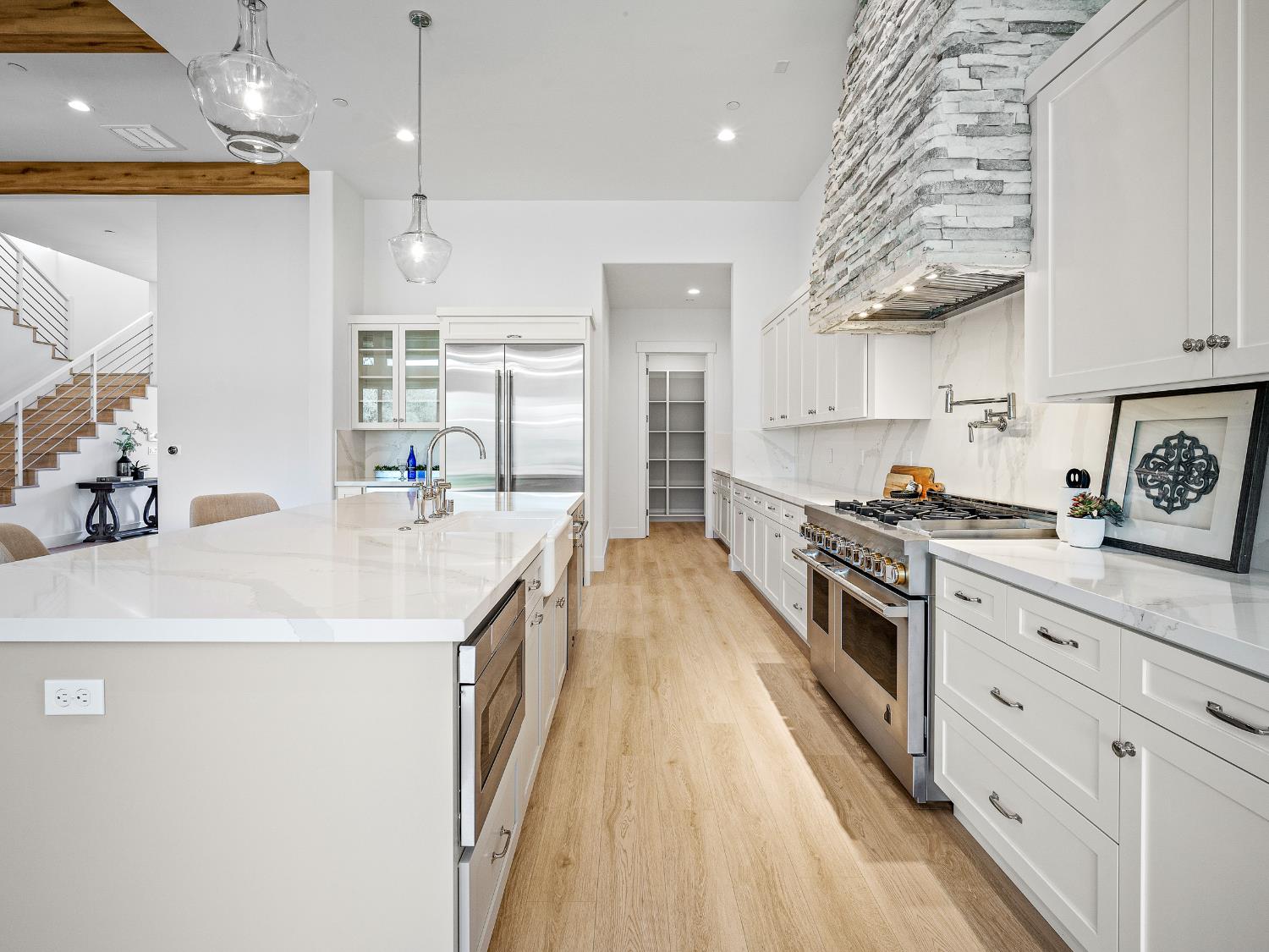 8118 Bridger Lane Shingle Springs, CA 95682 - Photo 14 of 59 a kitchen with stainless steel appliances granite countertop a lot of counter space and wooden floors