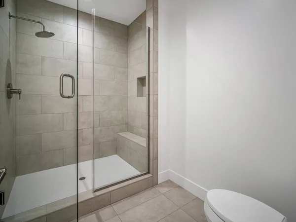 a living room with a bed and a flat screen tv