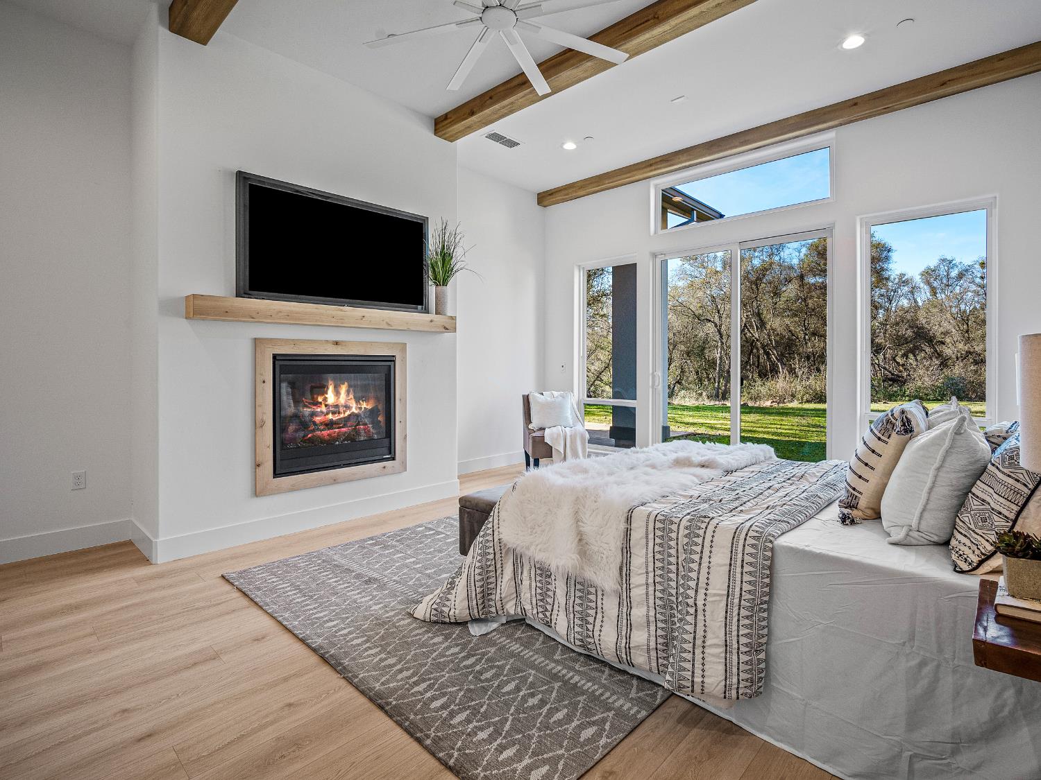 8118 Bridger Lane Shingle Springs, CA 95682 - Photo 22 of 59 a bed sitting in a spacious bedroom next to a window with a fireplace