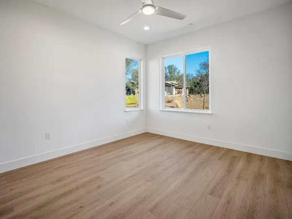 an empty room with windows and closet