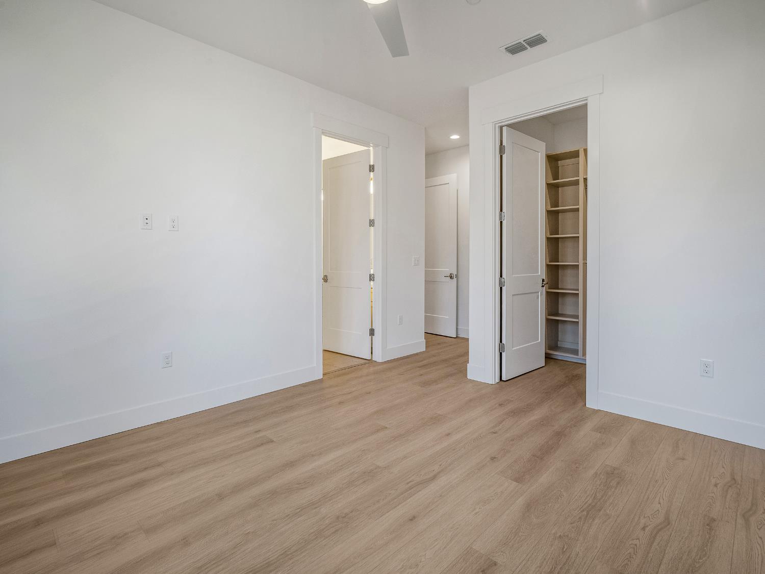 8118 Bridger Lane Shingle Springs, CA 95682 - Photo 30 of 59 an empty room with wooden floor & closet area