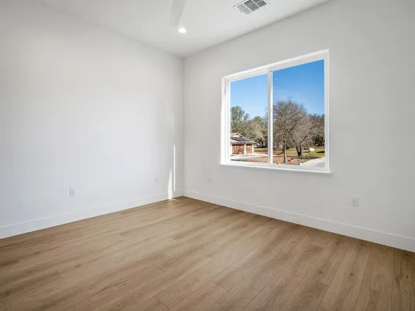 a dining room with furniture a chandelier and wooden floor