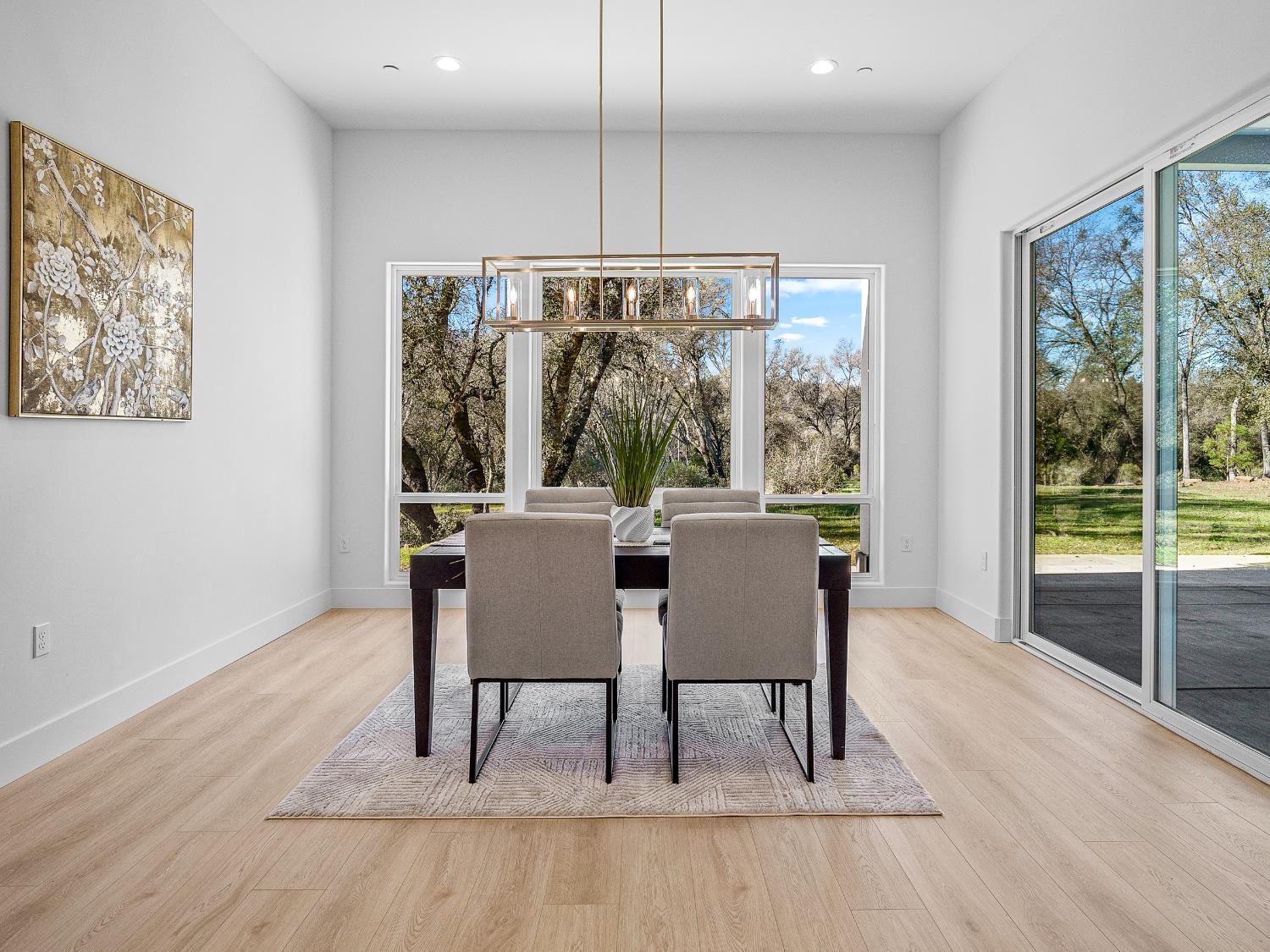 8118 Bridger Lane Shingle Springs, CA 95682 - Photo 35 of 59 a dining room with furniture a chandelier and wooden floor