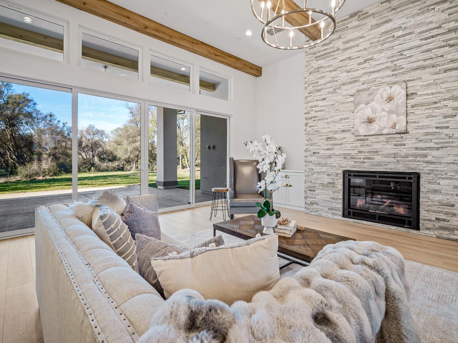 8118 Bridger Lane Shingle Springs, CA 95682 - Photo 39 of 59 a living room with furniture and a fireplace