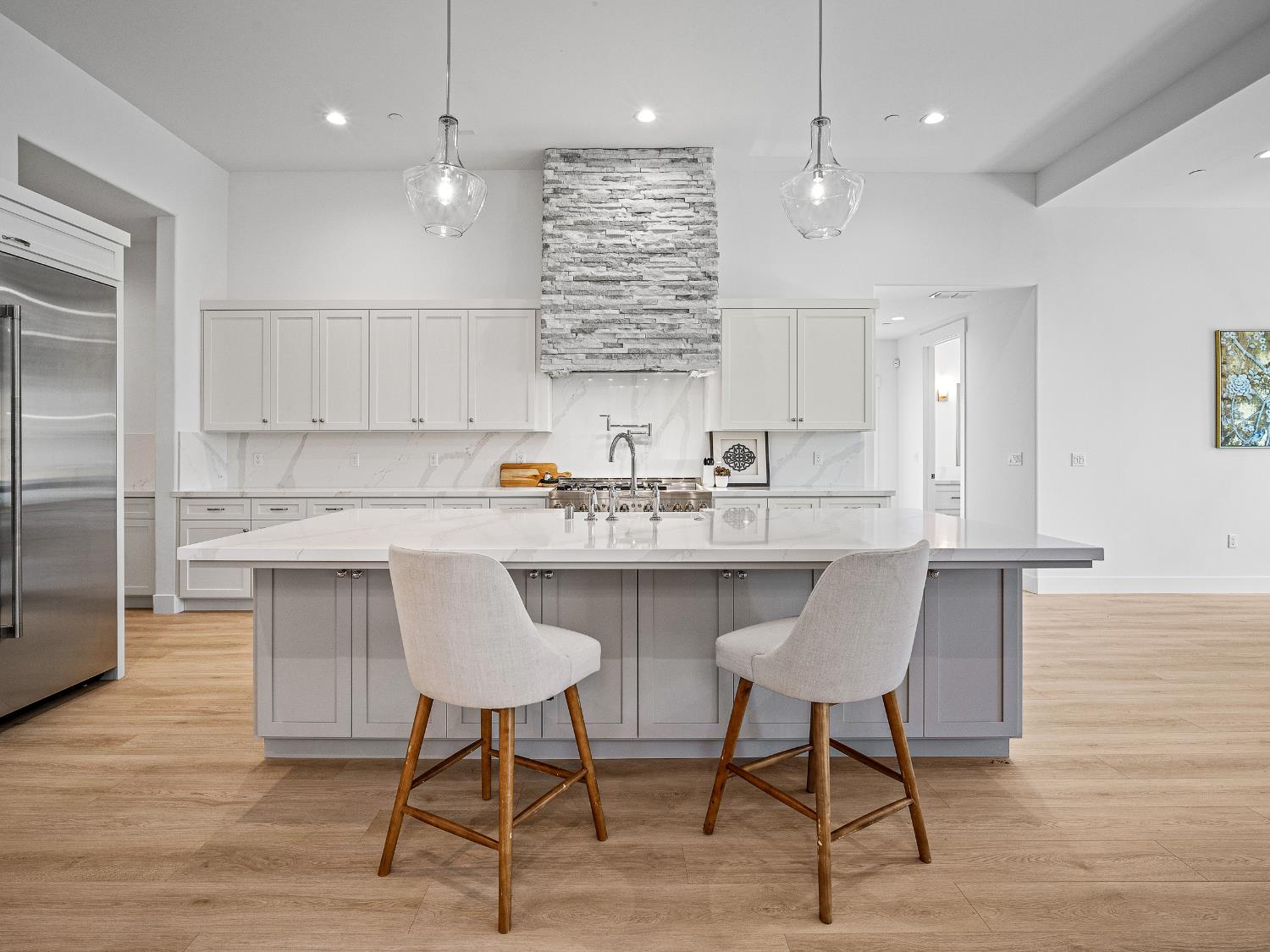 8118 Bridger Lane Shingle Springs, CA 95682 - Photo 4 of 59 a kitchen with stainless steel appliances granite countertop a table chairs sink refrigerator and cabinets