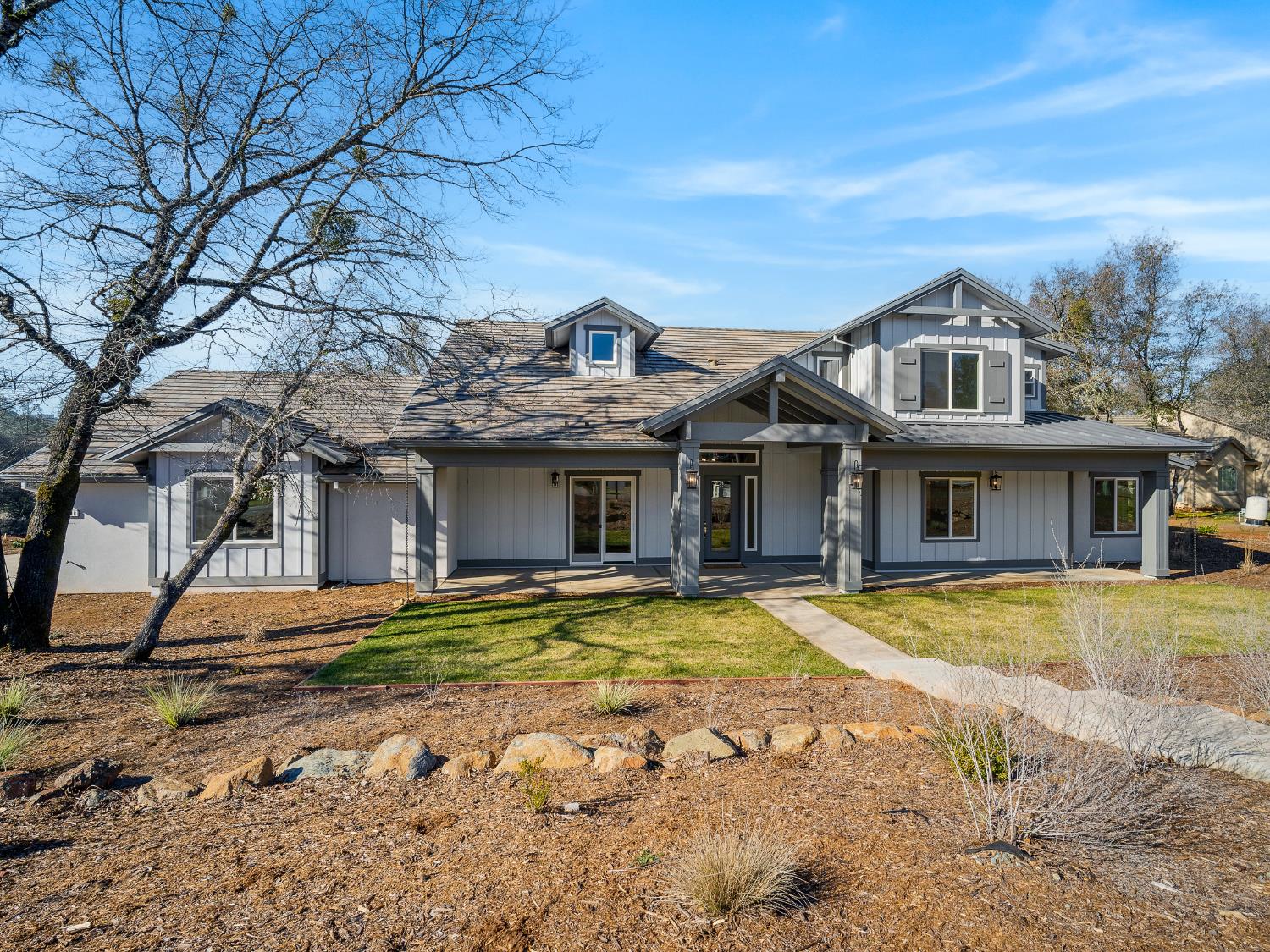 8118 Bridger Lane Shingle Springs, CA 95682 - Photo 45 of 59 a view of a white house with a large trees and playing yard