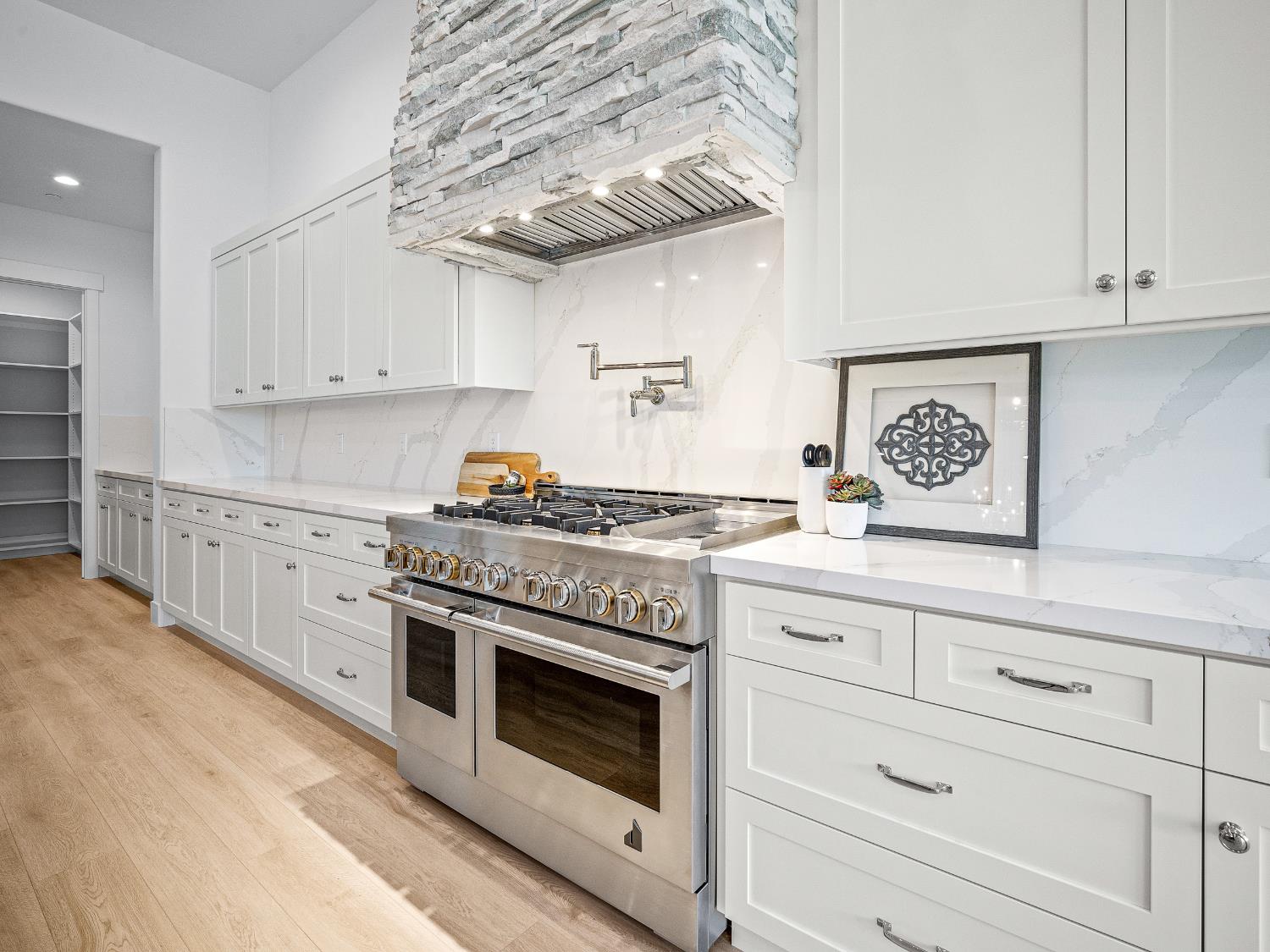 8118 Bridger Lane Shingle Springs, CA 95682 - Photo 5 of 59 a kitchen with cabinets appliances and a counter top