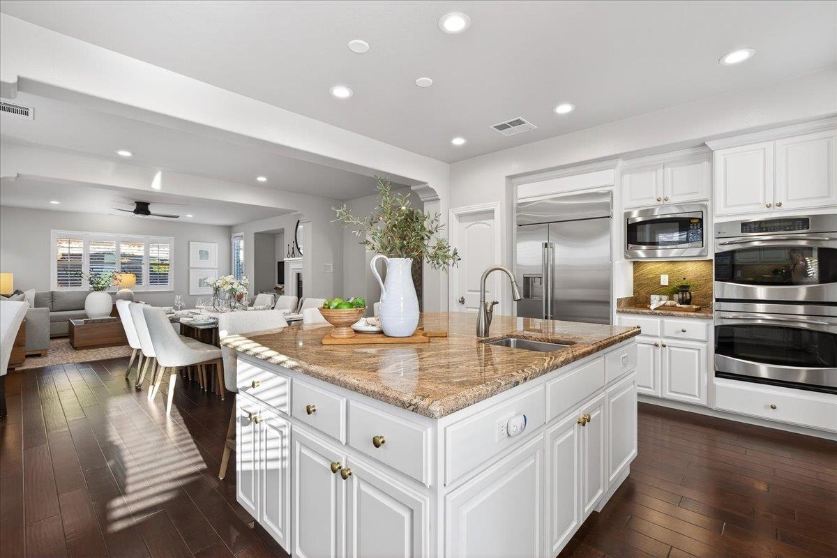 7035 Emerson Lane San Ramon, CA 94582 - Photo 16 of 60 a kitchen with stainless steel appliances granite countertop a lot of counter space and wooden floor
