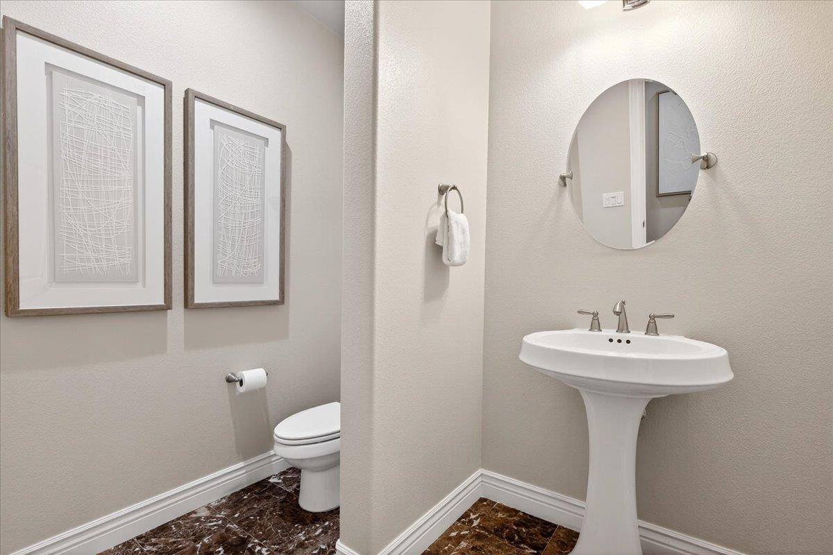7035 Emerson Lane San Ramon, CA 94582 - Photo 30 of 60 a bathroom with a sink a toilet and a mirror
