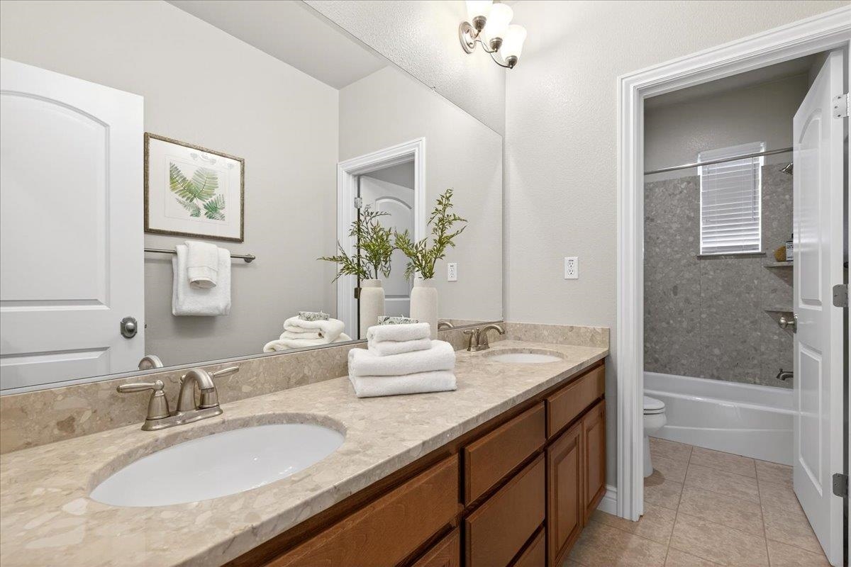 7035 Emerson Lane San Ramon, CA 94582 - Photo 40 of 60 a bathroom with a granite countertop sink and a mirror
