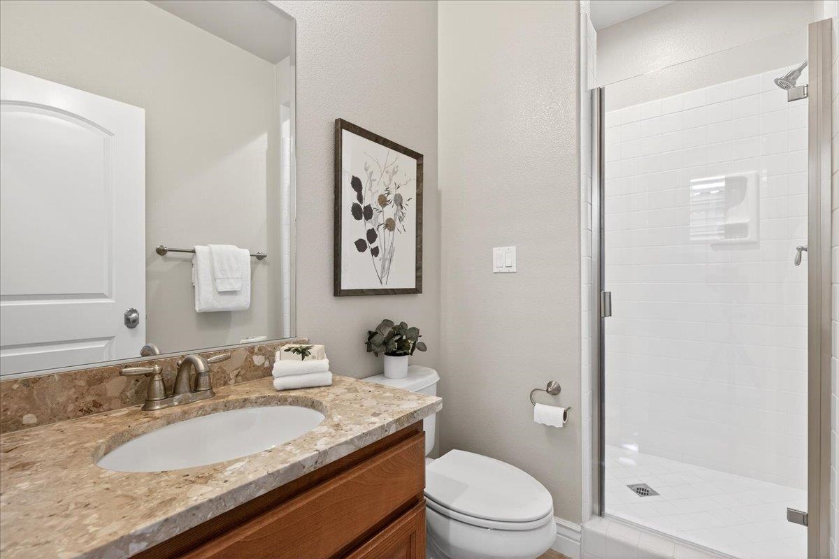 7035 Emerson Lane San Ramon, CA 94582 - Photo 49 of 60 a bathroom with a granite countertop sink a toilet and shower