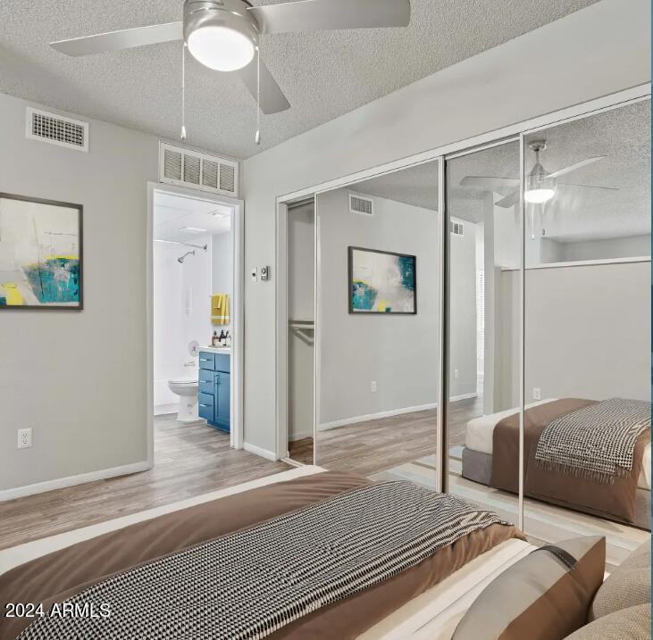 1311 West Baseline Road, Unit 1 Tempe, AZ 85283 - Photo 4 of 12 a bedroom with a bed and a chandelier