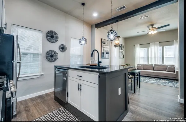 a living room with granite countertop furniture and a chandelier