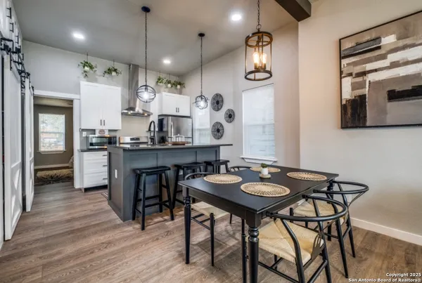 a view of a kitchen area with furniture and wooden floor
