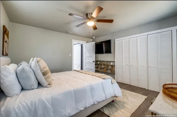 a bedroom with a bed and a television