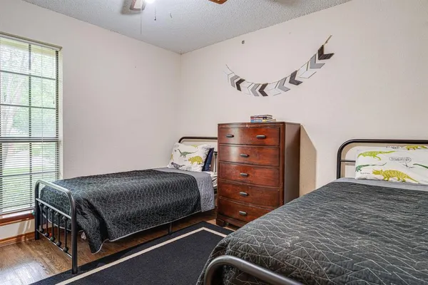 a bedroom with a bed and with windows