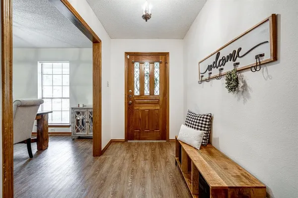 a view of an entryway with wooden floor