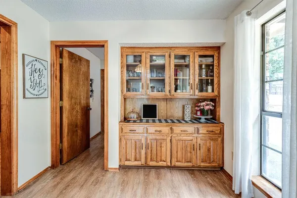 a room with a wooden floor and cabinets