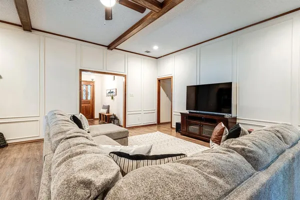 a bedroom with bed and a flat tv screen on a dresser