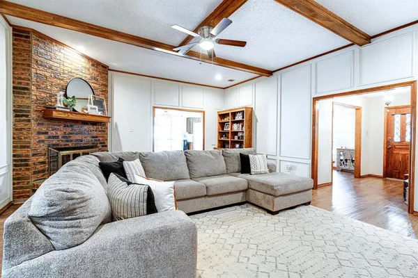 a living room with fireplace furniture and a flat screen tv