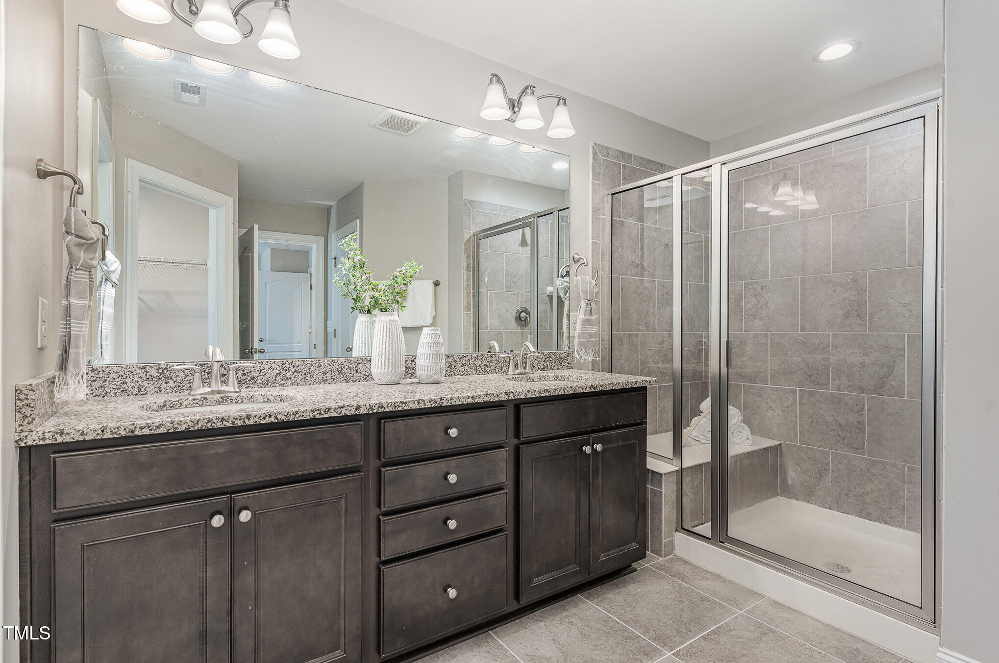 1314 Catch Fly Lane Durham, NC 27713 - Photo 16 of 31 a bathroom with a granite countertop sink a mirror a shower and a bathtub
