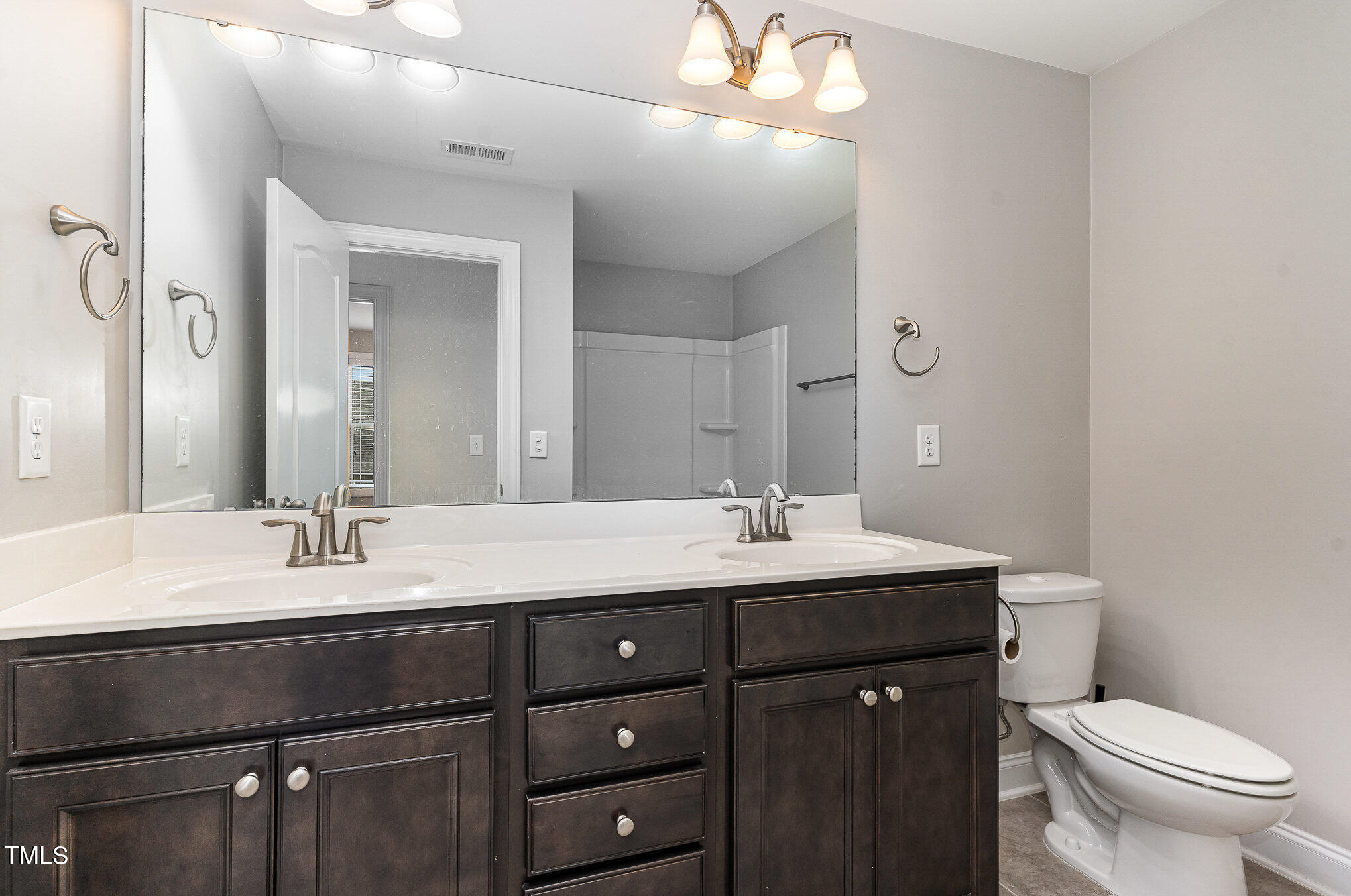 1314 Catch Fly Lane Durham, NC 27713 - Photo 20 of 31 a bathroom with a granite countertop sink a toilet and a mirror