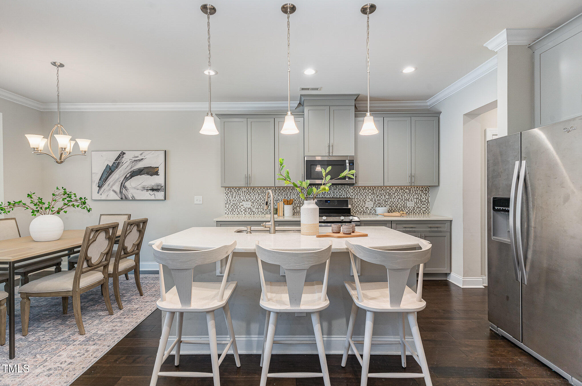 1314 Catch Fly Lane Durham, NC 27713 - Photo 8 of 31 a kitchen with kitchen island a dining table chairs and a refrigerator