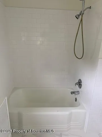 a bathroom with a bath tub and a shower