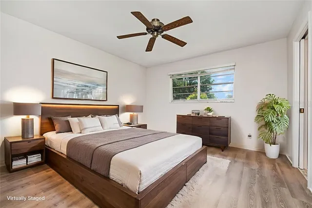 a bedroom with a large bed and a chandelier