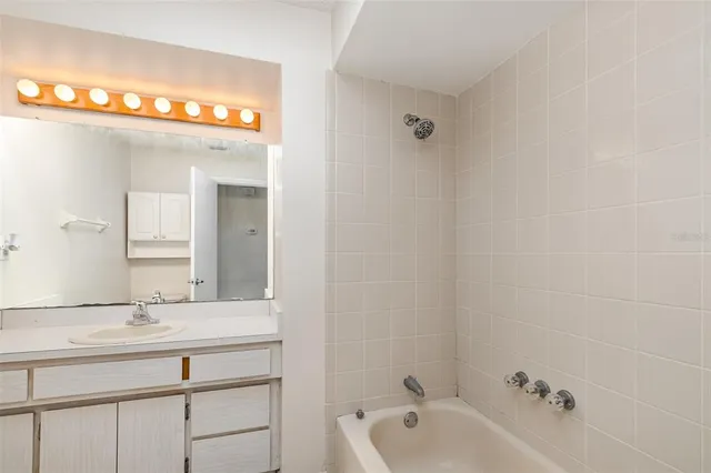 a bathroom with a sink a mirror and a bathtub