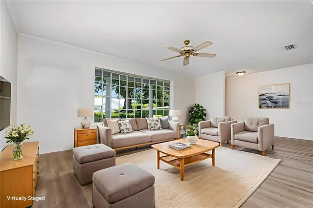 a living room with furniture a table and a large window