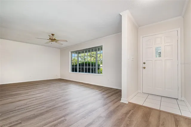 wooden floor in an empty room with a window