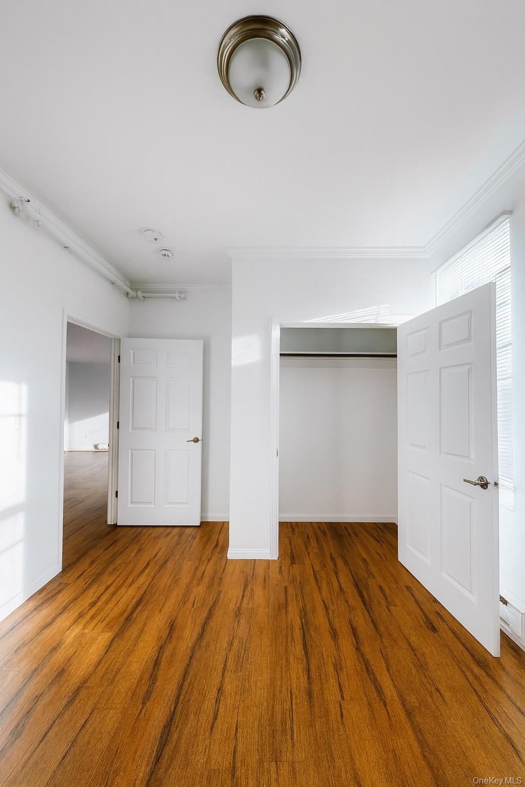 422 Broadway, Unit 6 Monticello, NY 12701 - Photo 5 of 7 a view of empty room with wooden floor